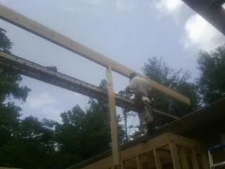 Carpenter setting a ridge beam over a new addition frame — Ice Dam Removal by Roofing Brothers in Lanoka Harbor