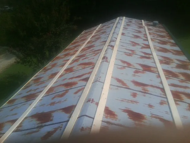 Rusted metal roof panels with new wood purlins before replacement — Storm Damage Roof Repair in Lanoka Harbor by Roofing Brothers