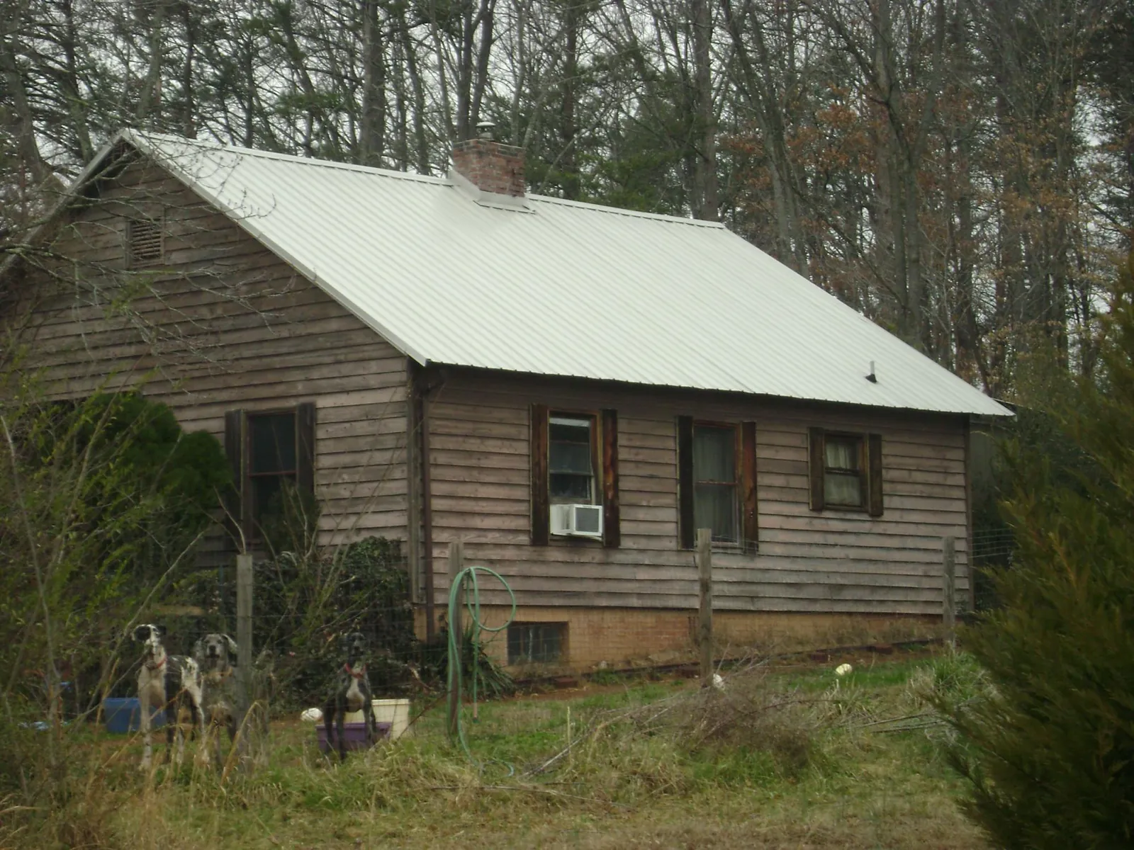 White metal roof on an old wood sided farmhouse, from a Metal Roof Installation job in Lanoka Harbor
